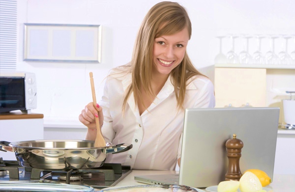 woman-cooking-near-laptop