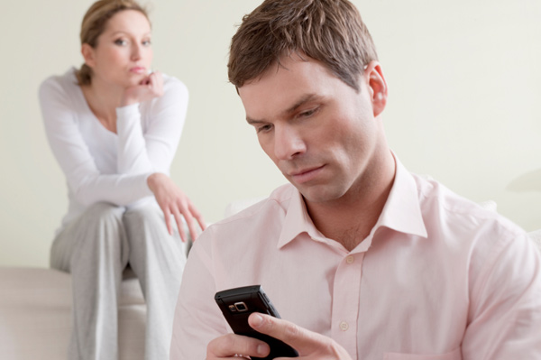 jealous-woman-watching-husband-on-phone