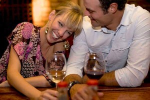 a man flirts with a woman at a bar