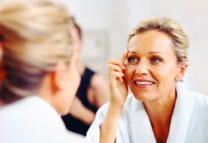 Woman examines her age in the mirror